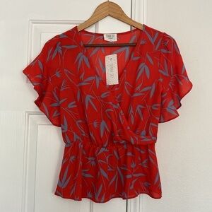 Sienna Sky NWT peplum blouse with flutter sleeves.